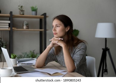 Pensive young Caucasian woman distracted form computer work read letter thinking pondering of problem. Thoughtful millennial female receive unpleasant news in document paperwork, make decision.