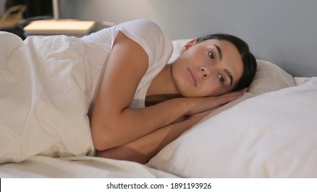 Pensive Young Latin Woman in Bed 