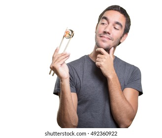 Pensive Young Man Eating Sushi