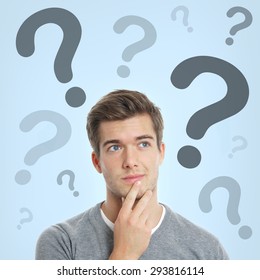 Pensive Young Man With Question Marks Above His Head