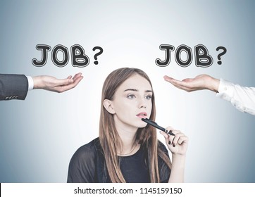 Pensive Young Woman With Long Fair Hair Holding A Pen Near Her Chin. A Gray Wall Background With Two Hands Offering Jobs. A Career Choice Concept