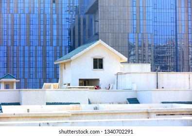 Pent House On The Roof Against Modern Glass Building