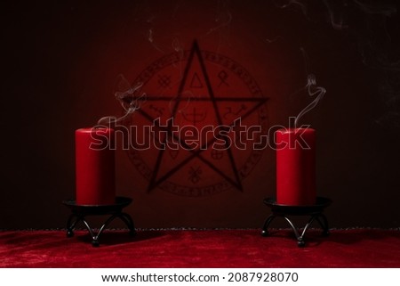 Pentagram symbol and candles. Black magic ritual or spell with occult and esoteric symbols. 

