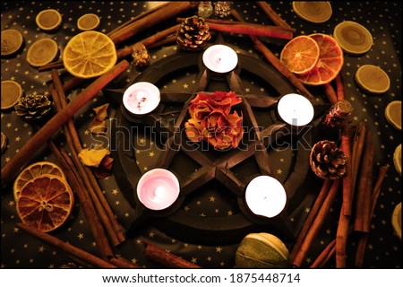 Pentagram with tealights and beautiful christmas yule background for real witch