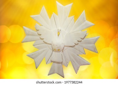 pentecost, representation of the holy spirit on bright yellow background