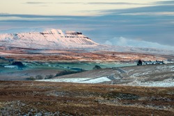 Pen-y-ghent Covered In Snow With Beautiful Winter Evening Sunlight. Yorkshire Dales National Park, UK.