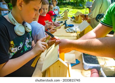 Penza. Russia-07.06. 2021: Child Learning To Make A Birdhouse. Close-up Of A Child's Hands With A Hammer Nailing A Board