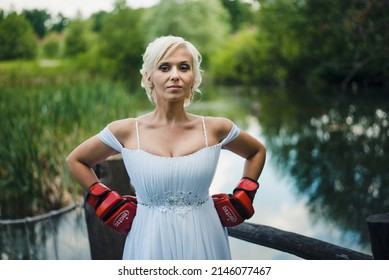 Penza, Russian Federation - June 8, 2016: Bride in boxing gloves. Wedding day. Bride in a wedding dress.