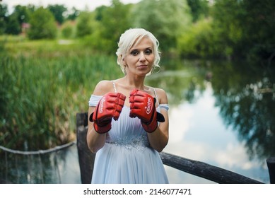 Penza, Russian Federation - June 8, 2016: Bride in boxing gloves. Wedding day. Bride in a wedding dress.