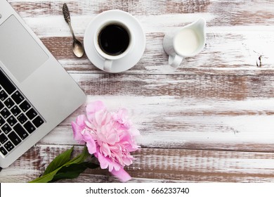 Peony, A Cup Of Coffee, Milk,spoon And Notebook Computer On A Wooden Table. Top View