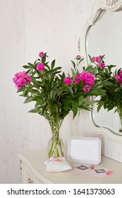 Peony Flowers Bouquet And Photo Frame On A Bedside Table. Home Interior With Decor Elements. Silver Frame, Peonies In A Vase, Interior Decoration. Bouquet With Blank Photo Frame Mock Up. Still Life