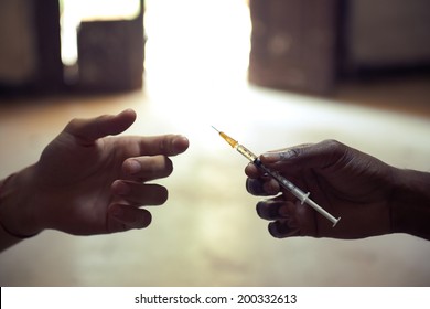 People abusing drugs, with African american man and caucasian guy sharing the same syringe to inject heroine