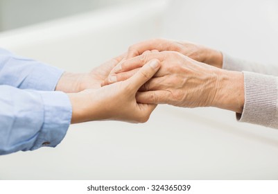 People, Age, Family, Care And Support Concept - Close Up Of Senior And Young Woman  Holding Hands