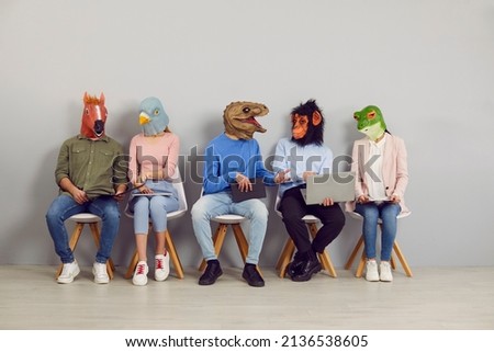 People with animal faces sitting in line waiting for job interview. Applicants in funny silly masks reading CVs and resumes and using laptops. College or university students discussing test or exam