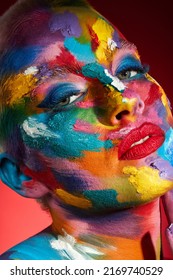 People Ask What My Favourite Colour Is And I Say All Of Them. Studio Shot Of A Young Woman Posing With Multi-coloured Paint On Her Face.