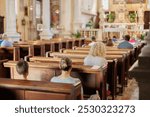 People attend a religious service in a historic church during a serene Sunday morning