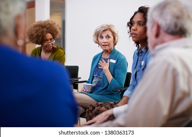 People Attending Self Help Therapy Group Meeting In Community Center