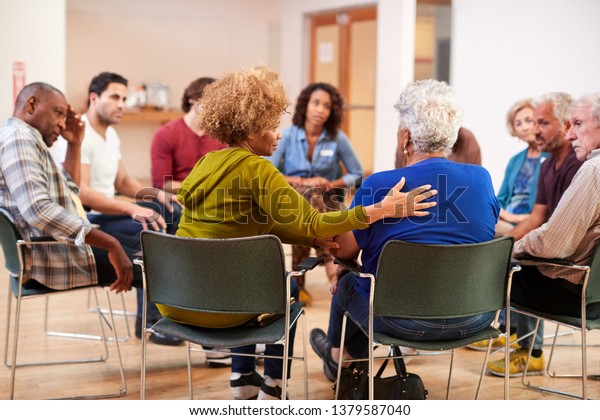 People Attending Self Help Therapy Group Meeting\
In Community Center