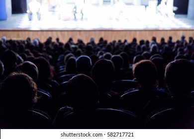 People In The Auditorium Looking At The Stage. Shooting From The Back