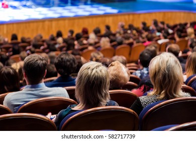 People In The Auditorium Looking At The Stage. Shooting From The Back