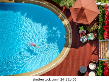 People Bathe In The Swimming Pool Of The Hotel View From Above.