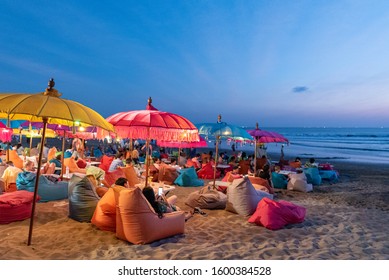 people at the beach drinking at a kuta beach bar