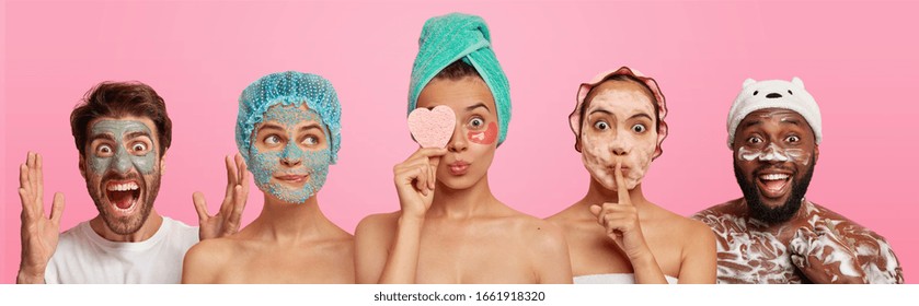 People And Beauty Concept. Emotional Man Goes Crazy, Applies Clay Mask, Three Women Stand Shoulder To Shoulder, Enjoy Cosmetic Treatment, Hold Sponge. Afro American Guy Washes Body With Foaming Gel