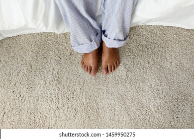 People, Bedtime And Rest Concept - Feet Of African American Woman In Pajama Pants Sitting On Bed