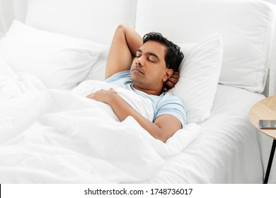 People, Bedtime And Rest Concept - Indian Man Sleeping In Bed At Home