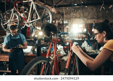 People, bicycle mechanic and fix with inspection for maintenance or small business at repair shop together. Young man, woman or cycling engineers working on bike with tools or equipment at workshop - Powered by Shutterstock