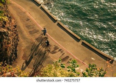 People Biking At Stanley Park Seawall, Vancouver, BC