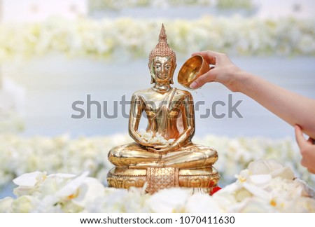 People blessing holy water and pay respects to Buddha statue on Songkran Festival or Thai New Year in the April month (Long holiday and summer seasons).