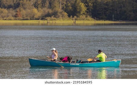 People Boating On A Forest Lake And Having Fun With Their Dog. Hiking And Traveling With A Dog. Travel Photo, Copy Space For Text, Selective Focus-August 25,2022-Vancouver BC Canada