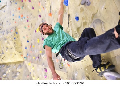 People Bouldering In A Climbing Hall - Indoor Sports 