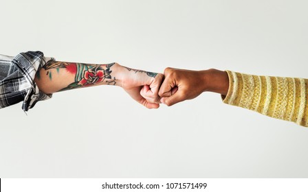People bumping their fists together - Shutterstock ID 1071571499
