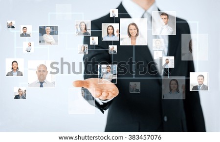 people, business, technology, headhunting and cooperation concept - close up of man hand showing business contacts icons projection