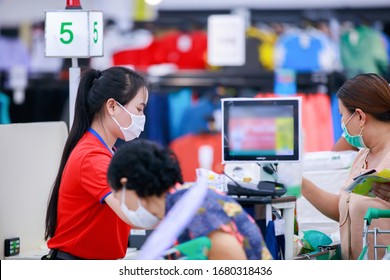 People Buying Goods In A Grocery Store.Cashier Or Supermarket Staff And Customers In Medical Protective Mask.covid-19 Spreading Outbreak  