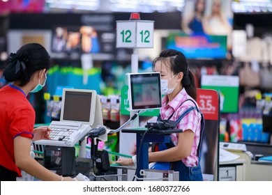 People Buying Goods In A Grocery Store.Cashier Or Supermarket Staff And Customers In Medical Protective Mask.hoard, Covid-19 Spreading Outbreak  