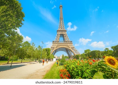 People by the world famous Eiffel Tower on a sunny day. Paris, France - Powered by Shutterstock