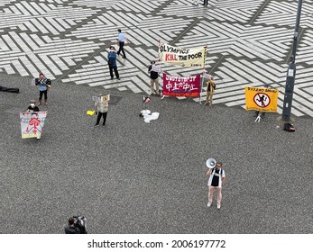 People Can Be Seen Protesting Against The Tokyo Olympics 2020 During The Unveiling Ceremony Of The Olympic Flame At Komazawa Olympic Park In Tokyo On July 9, 2021.