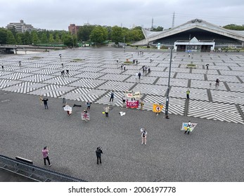 People Can Be Seen Protesting Against The Tokyo Olympics 2020 During The Unveiling Ceremony Of The Olympic Flame At Komazawa Olympic Park In Tokyo On July 9, 2021.