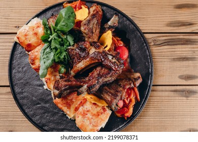 People Can See A Interesting Plate Of New Dish In The Traditional Restaurant. There Are A Lot Of Fried Meat On The Plate With Green Leafs On It. It Looks Very Delicious And Wonderful.