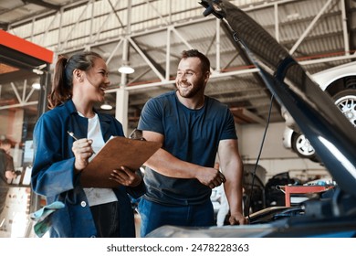 People, car mechanic and workshop with clipboard for inspection on teamwork, collaboration and maintenance. Happy, employee and vehicle repairs or service as engineer with small business and garage