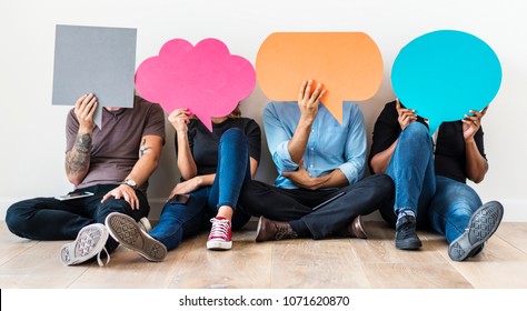 People carryng speech bubble icons - Shutterstock ID 1071620870