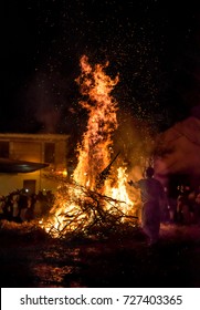 People celebrate St John's Eve around a bonfire in a greek village.
