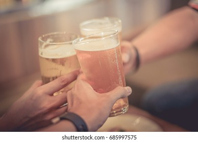 People Are Celebrating With A Glass Of Beer By Focusing At The First Glass Of Beer. Cheers.