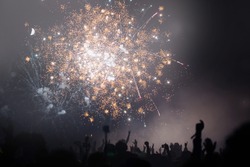 People Celebrating New Year's Eve With Raised Up Hands. Fireworks And Light. New Year's Eve Concept. 