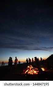 People Celebrating On The Beach In A Night