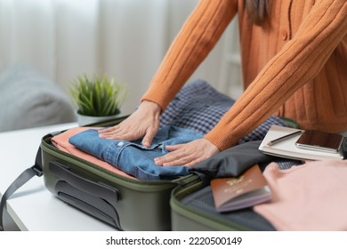 people check clothes into luggage in suitcase checklist before holidays trip