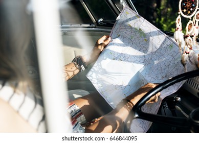 People Checking The Map for Direction on Road Trip